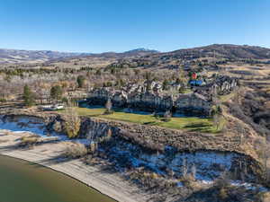 Birds eye view of property featuring a water and mountain view