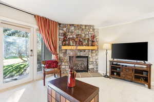 Living room with carpet flooring and a fireplace