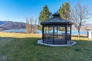 View of yard with a gazebo and a water and mountain view