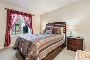 Bedroom with light colored carpet