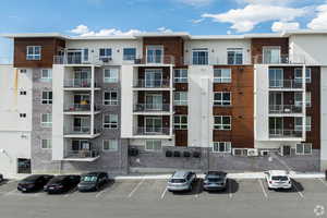 View of building exterior featuring cooling unit