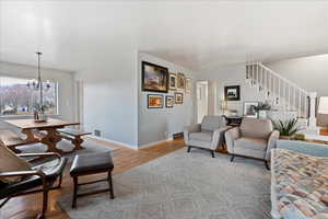 Living room featuring a notable chandelier and light hardwood flooring