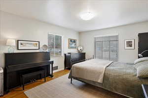 Main floor Bedroom featuring hardwood floors