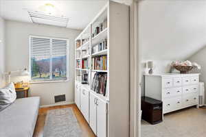 Living area featuring vaulted ceiling and light wood flooring