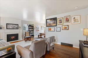 Living room featuring hardwood floors and a fireplace