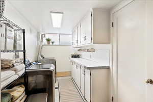 Laundry area with cabinets and independent washer and dryer