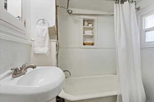 Bathroom featuring shower / bath combo and sink