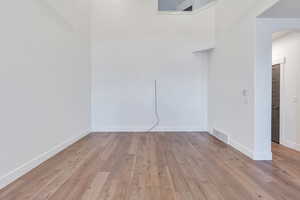 Unfurnished room featuring light wood-type flooring