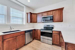 Kitchen featuring light hardwood / wood-style floors, sink, and stainless steel appliances