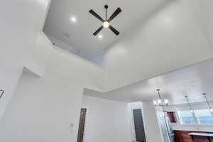 Interior details with ceiling fan with notable chandelier and stainless steel fridge