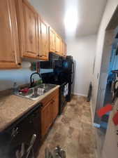 Kitchen featuring sink and black appliances