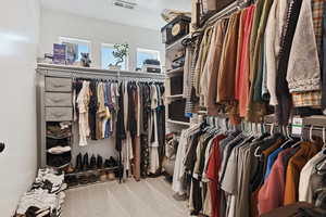 Walk in closet featuring light carpet