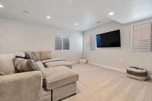 Living room featuring light carpet and a textured ceiling