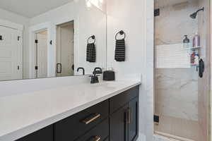 Bathroom featuring vanity and a shower with shower door