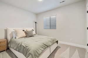 Bedroom featuring light colored carpet