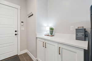 Doorway to outside featuring dark tile patterned floors