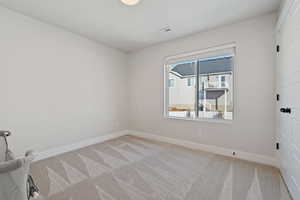 Spare room featuring light colored carpet