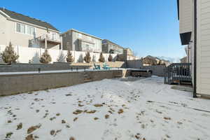 Snowy yard featuring a jacuzzi