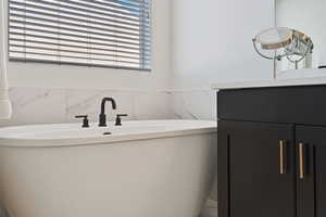 Bathroom featuring vanity and tile walls