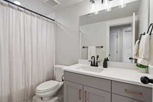 Bathroom featuring vanity and toilet