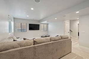 Carpeted living room with a textured ceiling