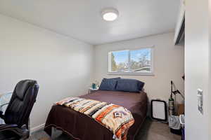 Bedroom 2 with dark laminate flooring.