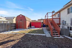 View of yard with a sheds, deck and cooling unit