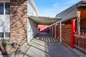 View of parking featuring a carport