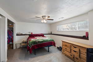 Large bedroom 5 with a closet, ceiling fan, new carpet and paint.