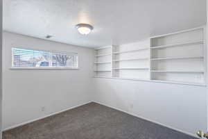 Bedroom 3 featuring new paint and carpet floors and built in shelves