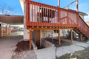 Back of property with a deck,central AC unit and walkout basement.