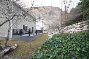 View of yard featuring a deck with mountain view