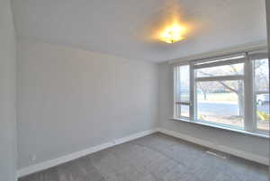 Bedroom room featuring carpet floors and a beautiful large window.