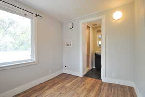 Dining room featuring plenty of natural light and dark hardwood / wood-style flooring.  There is a hookup for their own washer and dryer here as well.