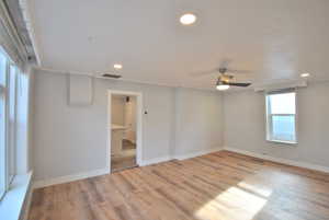 Living room with ceiling fan and light wood-type flooring