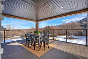 Snow covered patio featuring a mountain view