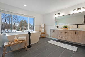 Bathroom with vanity, tile patterned floors, and a bathing tub