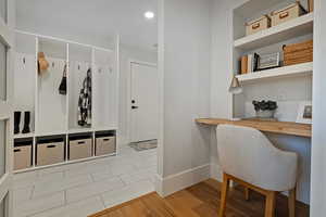 Mudroom with light hardwood / wood-style flooring