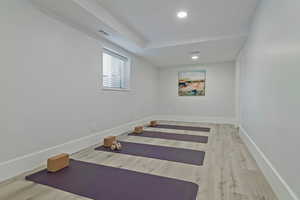 Workout area with hardwood / wood-style floors