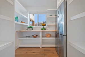 Interior space featuring stainless steel fridge and light hardwood / wood-style floors