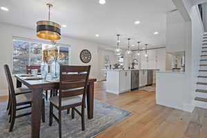 Dining space featuring sink and light hardwood / wood-style floors