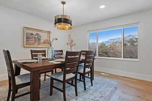 Dining space featuring hardwood / wood-style flooring and a mountain view