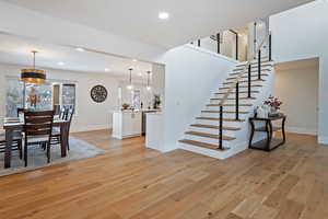 Stairs with hardwood / wood-style floors and sink