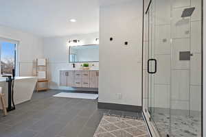 Bathroom with vanity, plus walk in shower, and tile patterned flooring