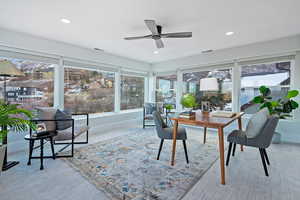 Sunroom featuring ceiling fan