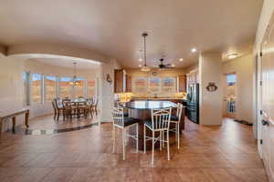 Dining room featuring ceiling fan with notable chandelier