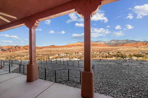 View of patio / terrace with ceiling fan and a mountain view