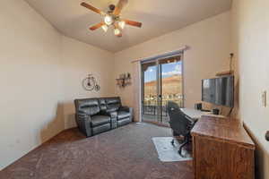 Office space with carpet floors and ceiling fan