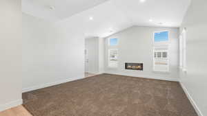 Living room with lofted ceiling and carpet flooring