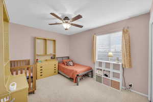 Bedroom with light colored carpet and ceiling fan